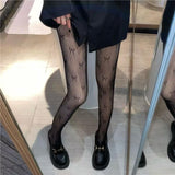 Collants résille à motif nœud papillon 