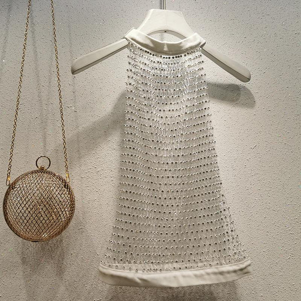 Haut à col ras du cou, boutonné et transparent avec perles 