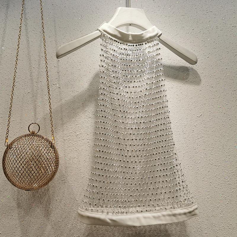 Haut à col ras du cou, boutonné et transparent avec perles 